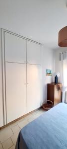 a bedroom with a large white cabinet and a bed at Casa Maris in Alcamo