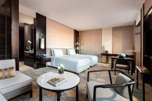 a hotel room with a bed and a table at Beijing Hotel NUO Forbidden City in Beijing