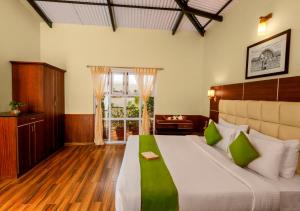 a bedroom with a large bed and a window at Rosewood by Nature Resorts and Stays in Ooty