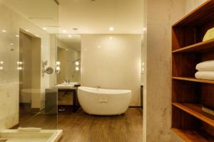 a bathroom with a large tub and a sink at The Fortress Resort & Spa in Koggala