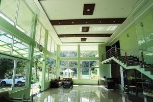 a living room with a staircase in a house at Belle Bonami Resort in Vagamon