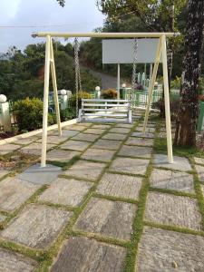a swing set in a park with a sign at Belle Bonami Resort in Vagamon