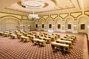an empty banquet hall with tables and chairs at Rixos President Hotel Astana in Astana +157 photos