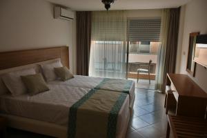 Postel nebo postele na pokoji v ubytování Hotel Residence Imiplage