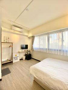 Säng eller sängar i ett rum på 日光寓 sunlight