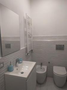 a bathroom with a sink and a toilet and a mirror at Casa in borgo marinaro in Giardini Naxos +10 photos