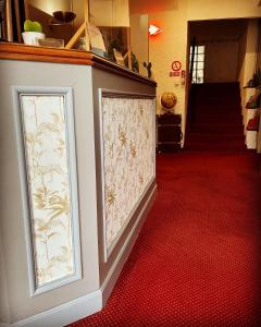 a hallway with two framed pictures on a wall at Hotel Italia in Tours