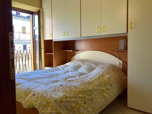 a bedroom with a bed with a blue and yellow blanket at Residenza Graziella in Bobbio Pellice
