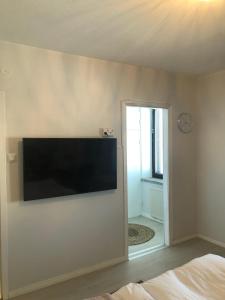 a flat screen tv on the wall of a bedroom at Studio in the center with free private parking in Kemi