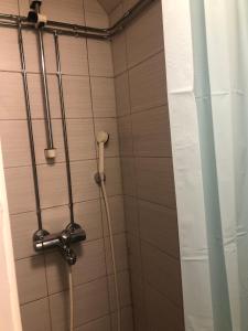 a shower in a bathroom with a shower curtain at Studio in the center with free private parking in Kemi