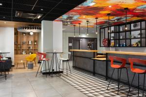 a bar with a painting on the ceiling at Ibis Marseille Centre Prefecture in Marseille