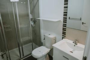 a bathroom with a shower and a toilet and a sink at Apartamentos ZHR 2 in Zahara de los Atunes