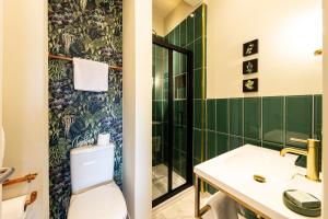 a bathroom with a toilet and a sink at Escape Boutique B&B in Llandudno