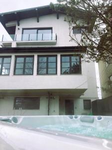 a house with a swimming pool in front of it at The Pines Boutique Villa in Braşov