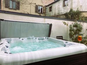 a jacuzzi tub sitting on a patio at The Pines Boutique Villa in Braşov