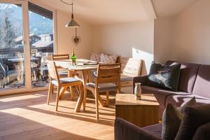 a living room with a table and chairs and a couch at Oberstdorfer Ferienwelt in Oberstdorf