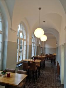 a restaurant with tables and chairs and windows at Waldbahnhof Sauerland in Brilon-Wald