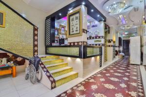 a lobby with a staircase in a store at Rahab Hotel in Dubai
