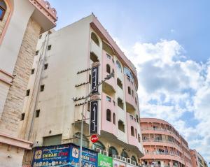 a pink building with a sign on the side of it at Rahab Hotel in Dubai