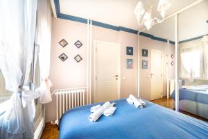 sypialnia z niebieskim łóżkiem i 2 ręcznikami w obiekcie Sava Centar 1-bedroom apartment in the heart of New Belgrade w Belgradzie