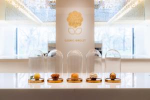 a display case with several pastries in glass domes at The Berkeley in London