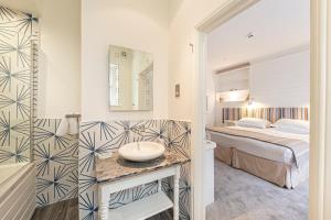 a bathroom with a bed and a sink in a room at Escape Boutique B&B in Llandudno