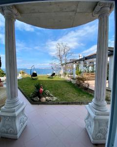 a porch with two columns and a view of the ocean at SunVilla with hot tub in Koper