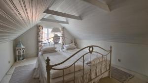 a bedroom with a canopy bed in a attic at Villa Luna Breakfast Hotel in Killeberg