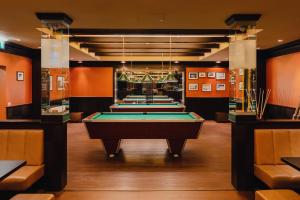 a row of pool tables in a room at Relax Resort Hotel Kreischberg in Sankt Georgen ob Murau