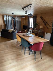 uma sala de estar com uma mesa de madeira e cadeiras em chalet au pieds des pistes le cambre aze em Bolquère - Pyrénées 2000