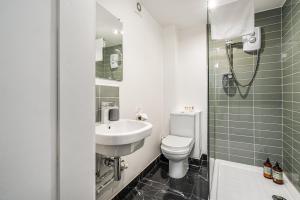 a bathroom with a sink and a toilet and a shower at The Renfrew Residence 4-bedroom, city centre in Glasgow