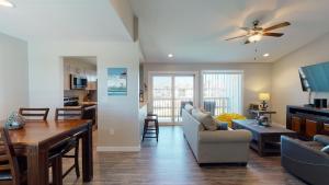 a living room with a couch and a table at AH-B204 Remodeled 2nd Floor Condo, Shared Pool & Hot Tub, Near Marina in Port Aransas