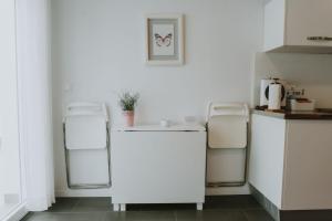 a kitchen with two white refrigerators and a counter at Apartamentos ZHR 2 in Zahara de los Atunes
