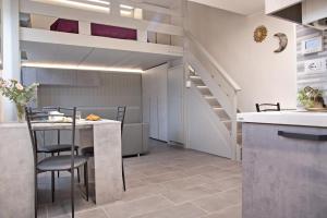 a kitchen and dining room with a loft bed at Efihouse Lago Maggiore in Luino