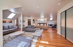 a living room with a couch and a bed at Les Suites at The Cliff Bay - PortoBay in Funchal