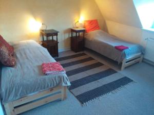 a room with two beds and two night stands at Gästewohnung SEETOR in Lenzen