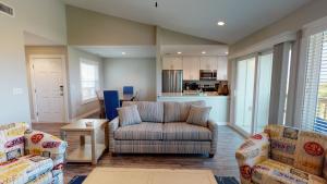 a living room with a couch and chairs and a kitchen at AH-K239 Newly Remodeled Second Floor Condo With Bay View, Shared Pool in Port Aransas