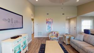 a living room with a couch and a table at AH-K239 Newly Remodeled Second Floor Condo With Bay View, Shared Pool in Port Aransas