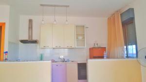 a kitchen with white cabinets and a sink at Francesco&Maria in Villaggio Tedeschi