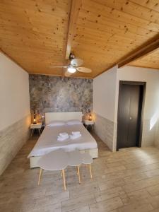 a bedroom with a bed and two tables and a ceiling at Albachiara Guest House in Fiumicino