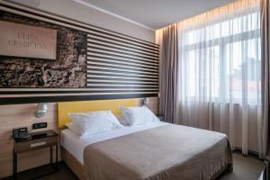 a hotel room with a bed and a window at Hotel Lero in Dubrovnik