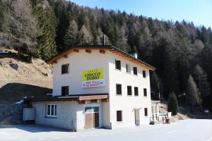 a building with a sign on the side of it at Hotel Sfazù in Poschiavo