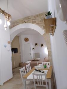 a dining room and living room with a table and chairs at Casa vacanze LaCorte ByFrancy in Bari +12 photos