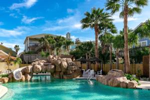 a pool with a water slide in a resort at BC508 Townhome with Beach Inspired Decor, Heated Pool with Water Slide in Port Aransas