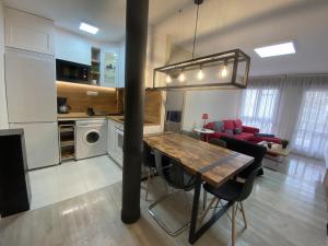 a kitchen and living room with a table and a couch at Azcona - 6004 in Noja