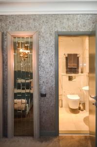 a bathroom with a toilet and a sink at Home Boutique Hotel in Baku