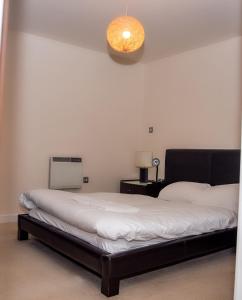 a bedroom with two beds and a light at Mercury Apartments in Leeds