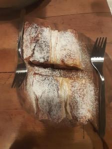 a piece of bread on a plate with a fork at PANEERIPOSO in Pergine Valsugana