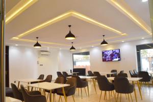 a dining room with tables and chairs at HIS Dulce Apartments in Lagos