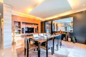 a dining room with a table and a kitchen at Ultimate Luxury sea front villa with private pool Palm Jumeirah in Dubai